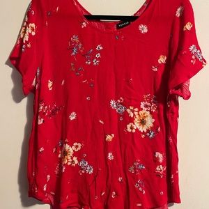 Red floral shirt with cute buttons along the back,
